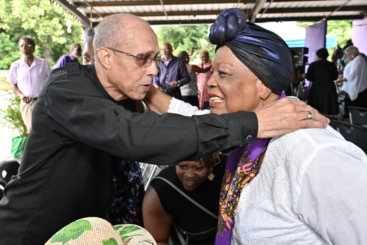 Aldrick ‘Ali’  McNab chats with the legendary Judy Mowatt, at the thanksgiving service on Wednesday.
