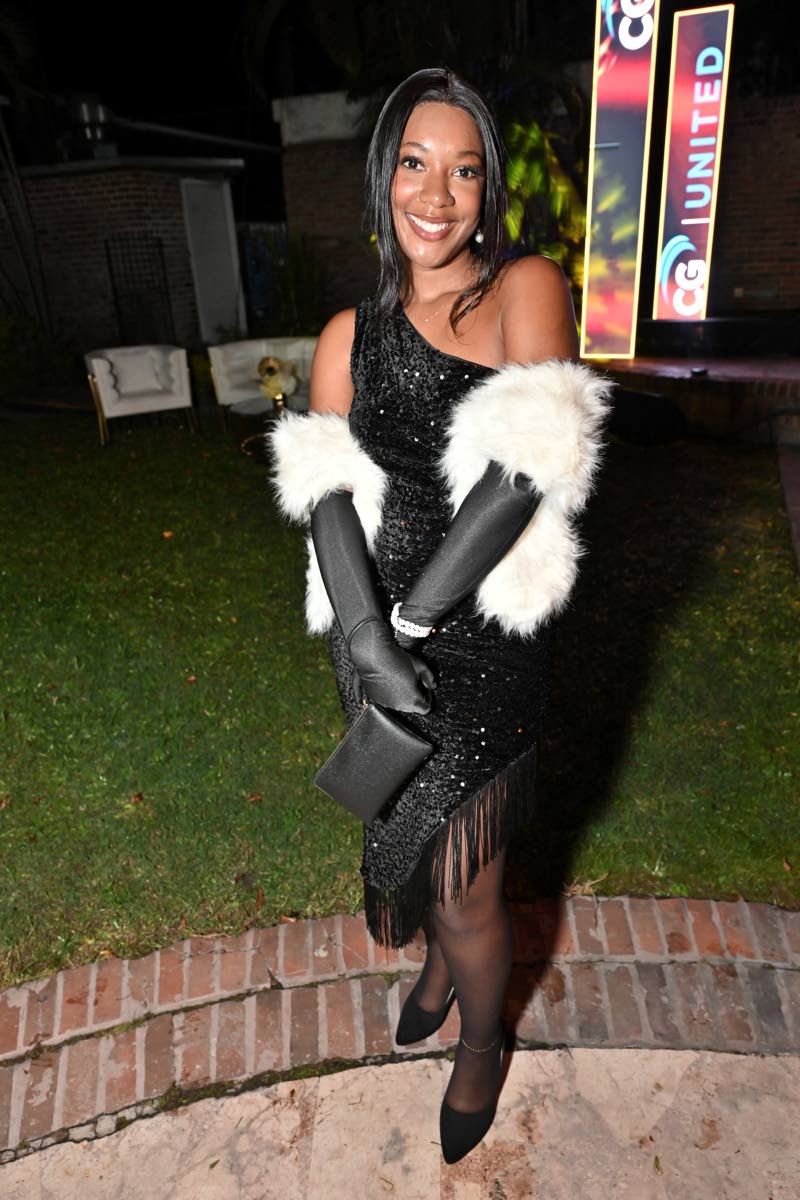 Antonique Aris completes her all-black look with a white fur stole.