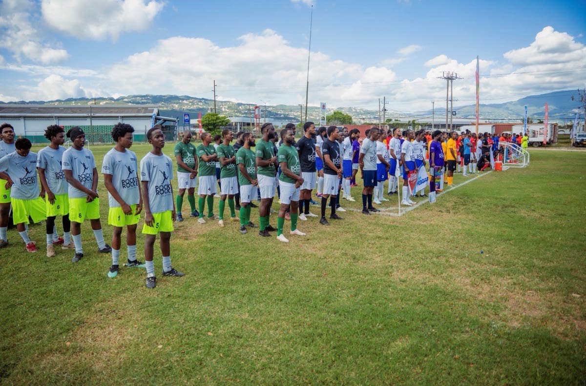 Participating teams line up for the dress parade during the opening ceremony of the Pocket Rocket Foundation’s 10th annual Six-A-Side Peace Through Sports Football Competition at the Red Stripe Sports Complex in Kingston on Saturday.  