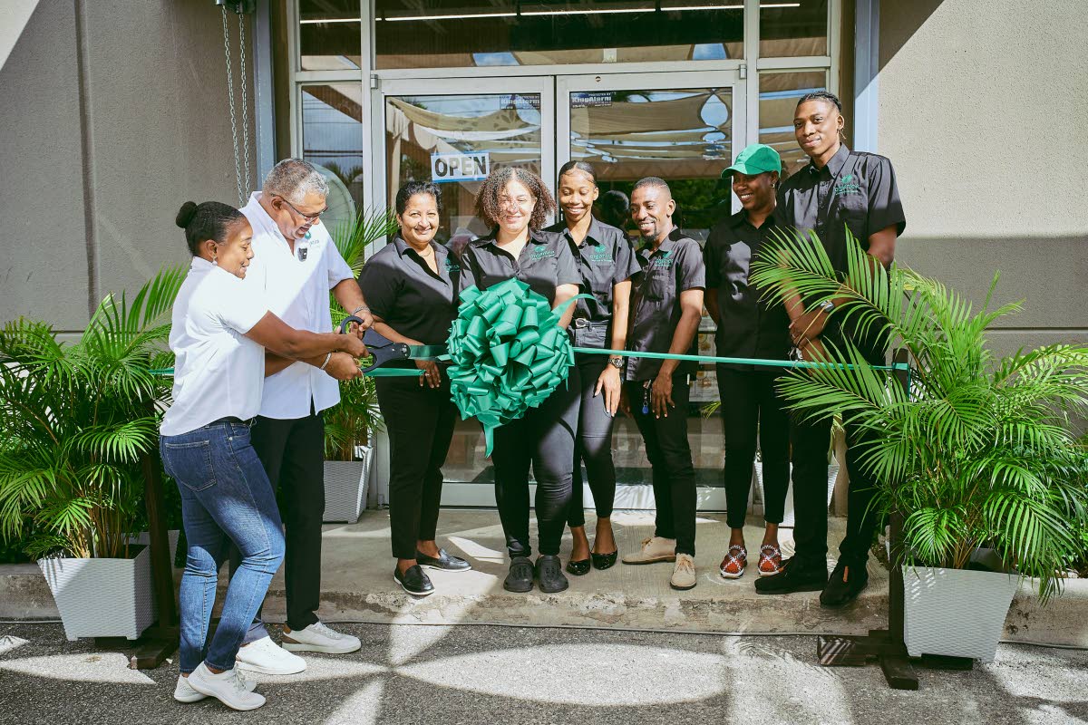From left: Abbi-Gaye Phillipps, co-founder and managing director, and Krishna Phillipps, co-founder and director, cut the ribbon during the opening of Organica Whole Foods Store’s new Montego Bay location in St James. They are joined by team members (fro