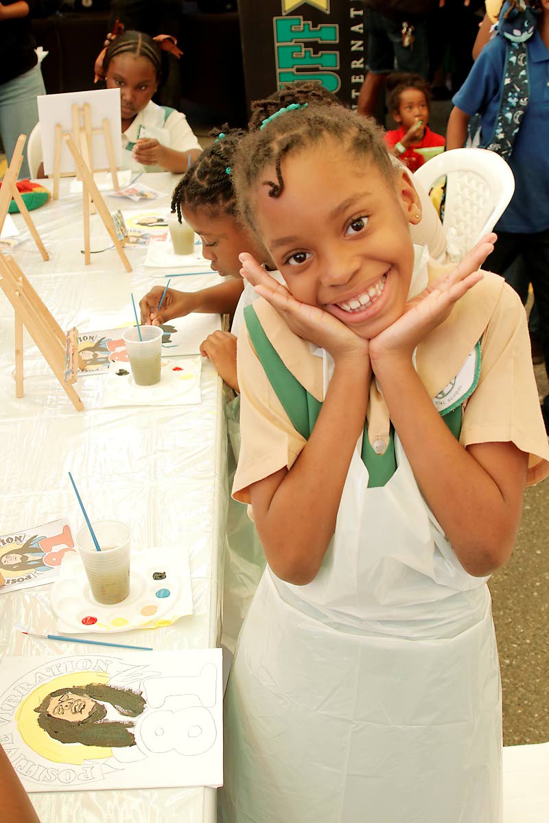 Adelyn Mothersill was all smiles as she painted a portrait of the late Bob Marley at his 81st birthday celebration on Friday at the Bob Marley Museum