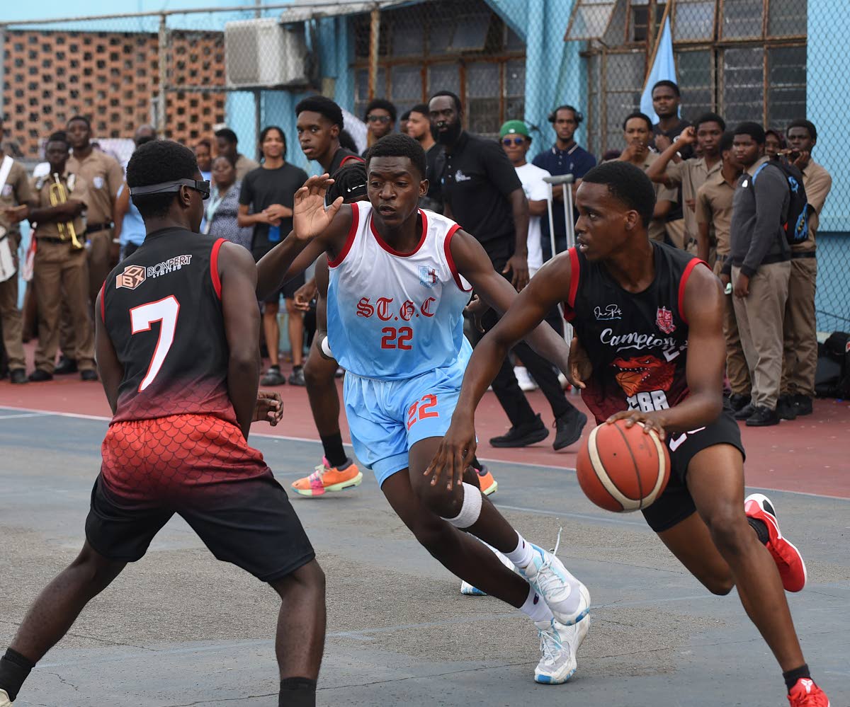 Zachery Lawrence-Smith (right) of Campion College dribbles past Imani Salmon (centre) of St George’s College during the ISSA urban Under 19 Basketball finals match at St George’s College on Tuesday.  Looking on at left is Dylon Kelly  from Campion Coll