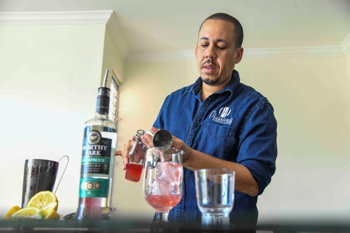 Hudson’s Cocktail Story’s Wynton Hudson pours his watermelon cucumber cordial into a goblet.