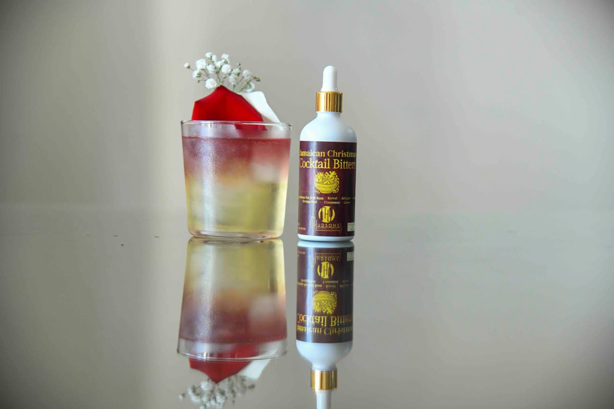The boonoonoonoos mocktail — with splashes of Hudson’s Cocktail Story Jamaican Christmas Cocktail Bitters — is garnished with rose petals.