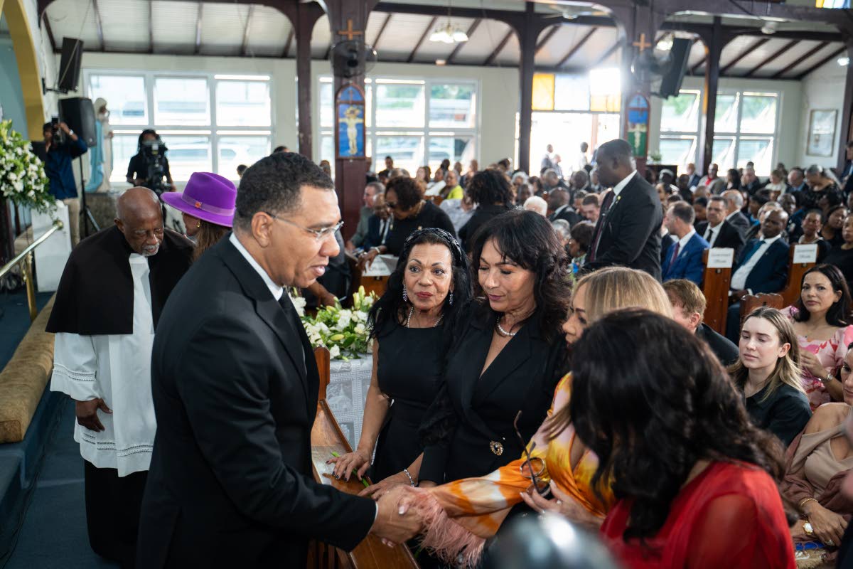 Prime Minister Dr Andrew Holness greets the family during the celebration of life for Christopher Bovell.