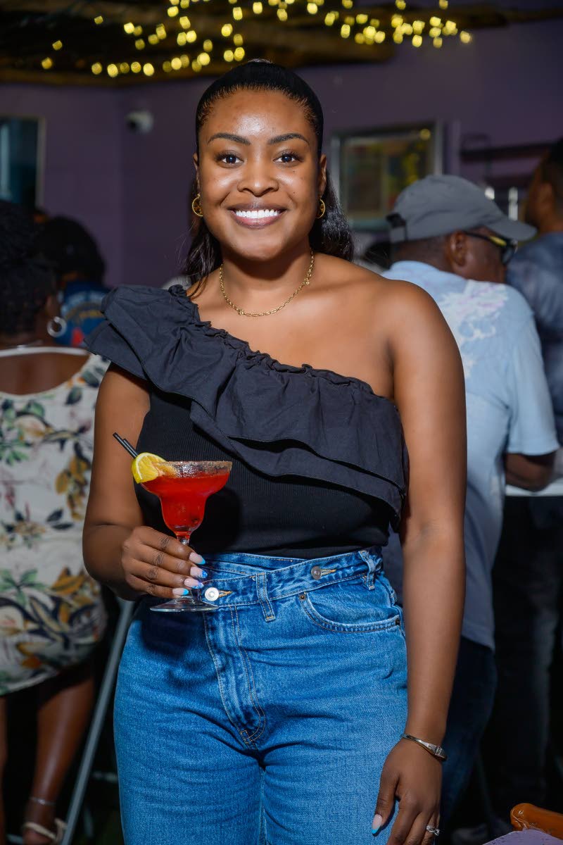  With cocktail in hand, Krystal Murad, attorney-at-law, flashes a bright smile for the camera.