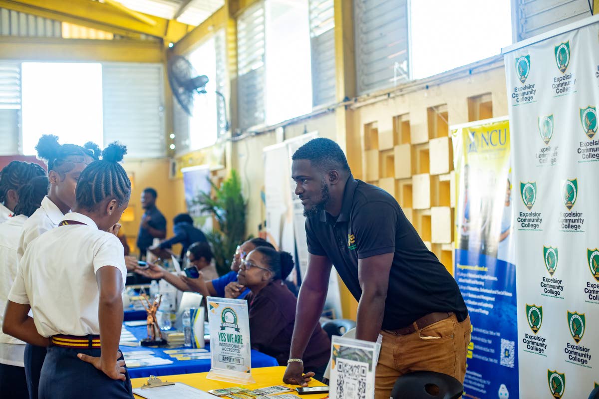 An exhibitor answers students’ questions at the Kiwanis Club of Linstead College Fair.
