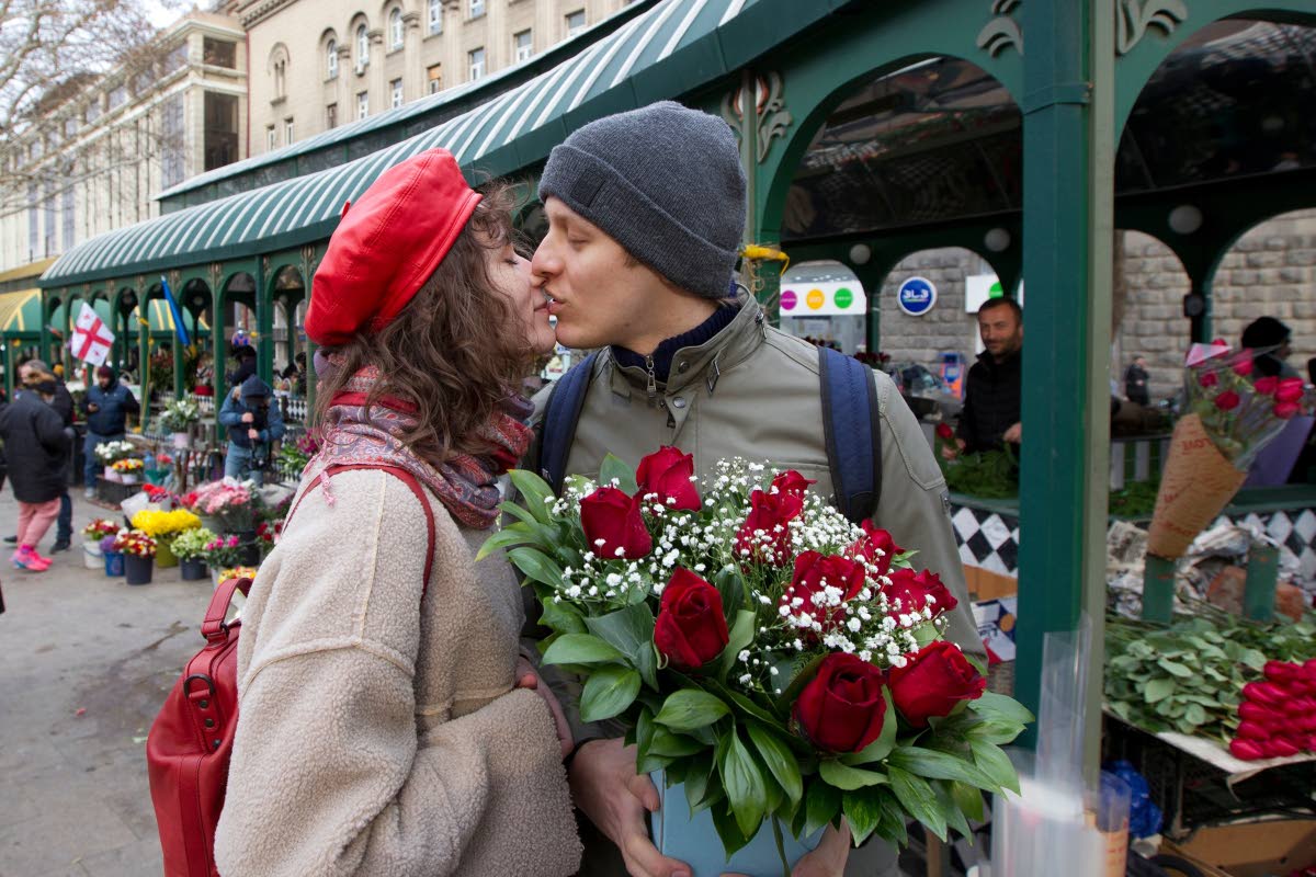 
A couple shares a tender moment near a flower market in Tbilisi, Georgia, in 2022.