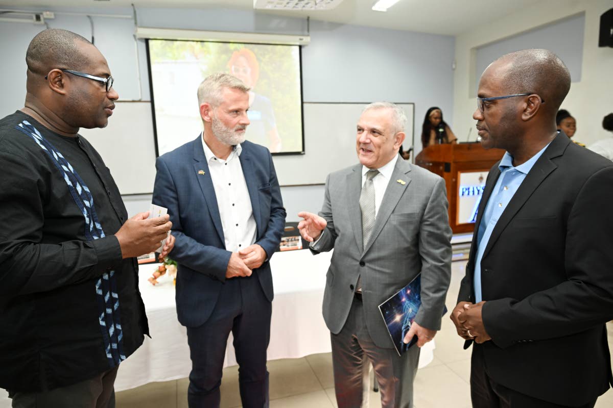 PS Foundation Chairman Damian Obiglio (second right) makes a point to University of the West Indies Principal and Vice Chancellor Denzil Williams (left) as German Ambassador to Jamaica Jan Hendrik van Thiel (second left) and Dr Louis-Ray Harris, senior lec