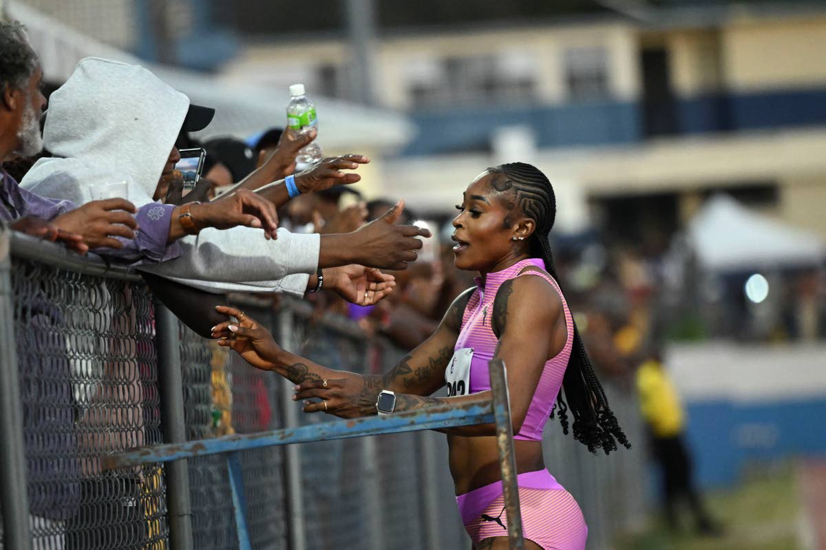  Elaine Thompson Herah greets fans after placing third in the 60 metres at last Saturday’s Camperdown Classic held at Ashenheim Stadium, Jamaica College.