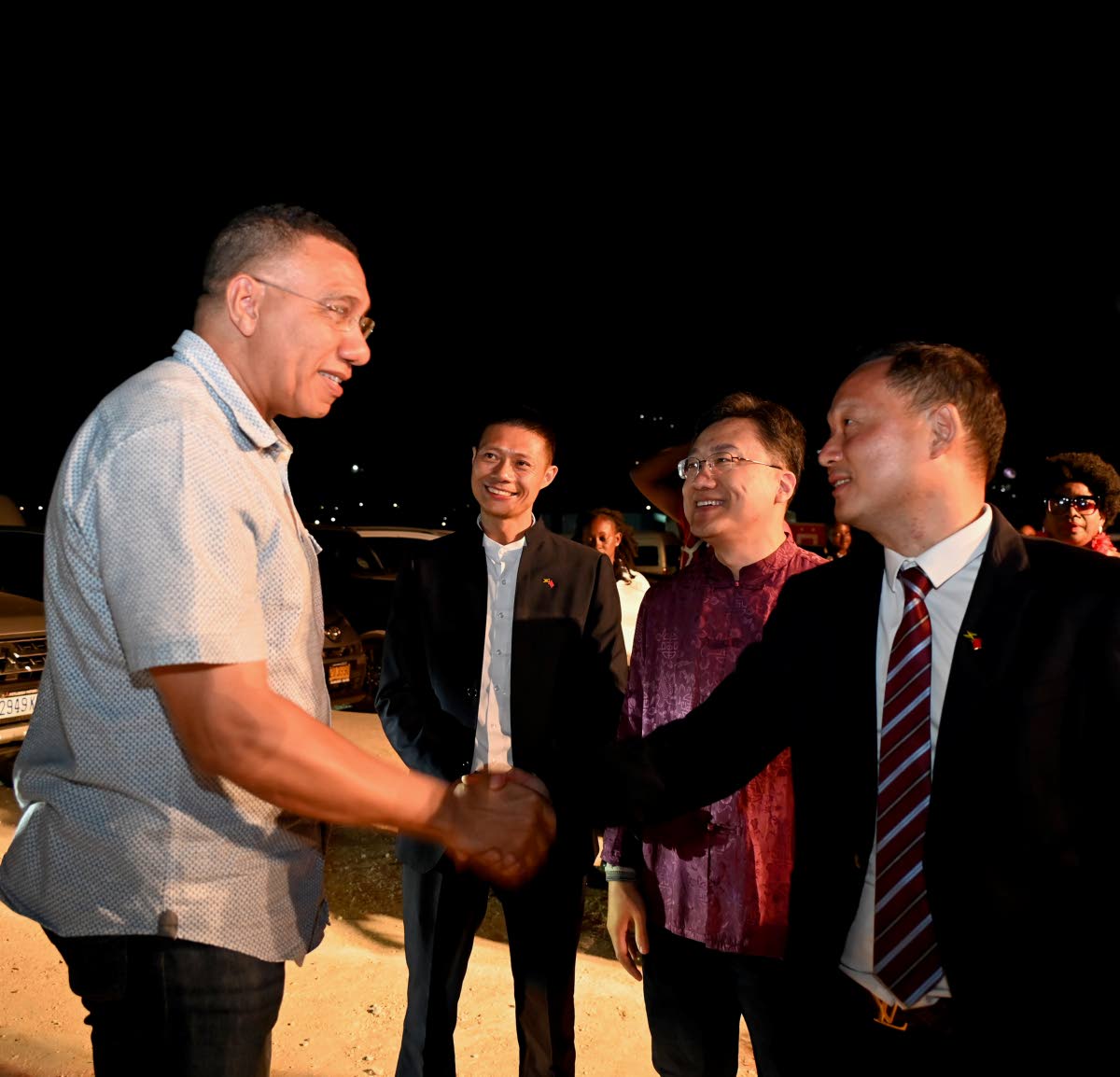 Prime Minister Dr Andrew Holness (left) greets Yangsen Li (right), CEO of LCH Developments, while Wang Jinfeng, ambassador of The People’s Republic of China to Jamaica (second right), and Shifu Huang, CEO of Caribbean Solar Life, look on during the Chine