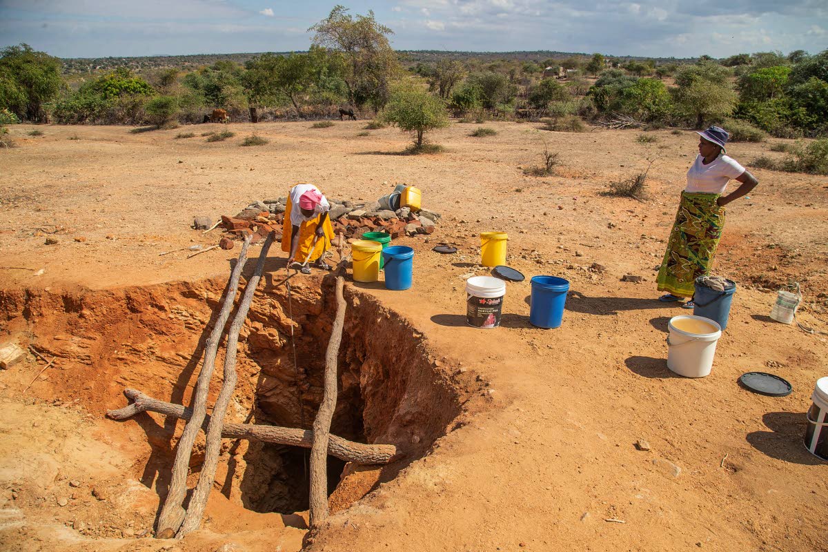 Villagers fetch water from a makeshift borehole in Mudzi, Zimbabwe, as the United Nations’ food agency says months of drought in southern Africa, triggered by the El Nino weather phenomenon, has had a devastating impact on more than 27 million people and
