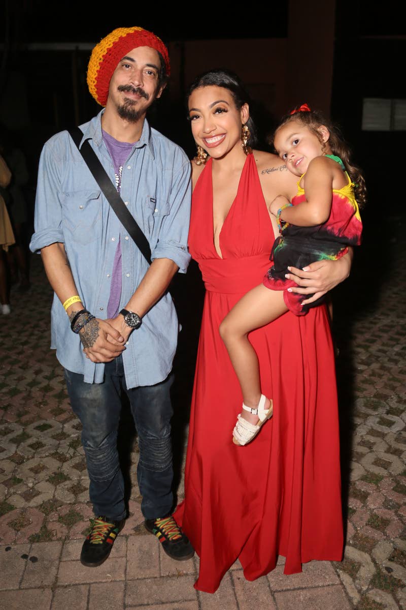 Shiah Coore, his sister Ashley Coore and Ashley’s daughter, Kailani, pose for a family snap as they honour their patriarch Stephen ‘Cat’ Coore.