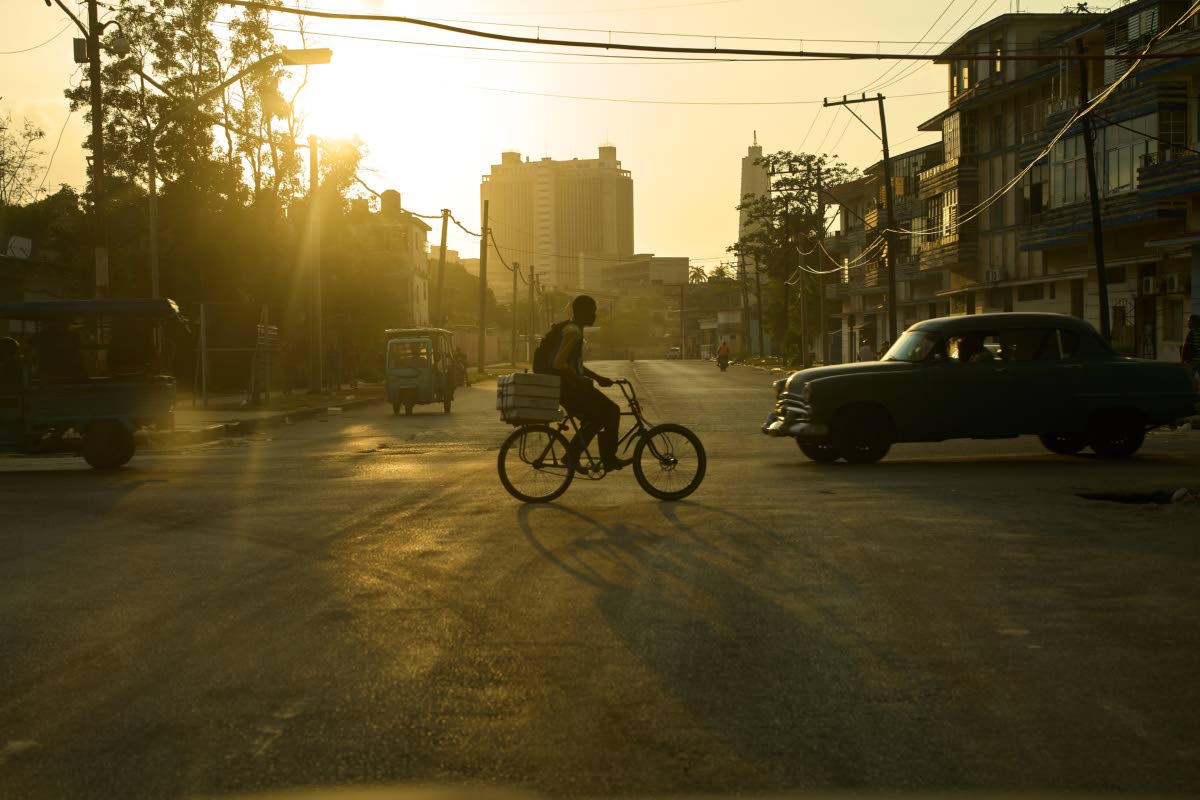 A man rides his bicycle at sunset in Havana, Wednesday, Feb. 18, 2026.
