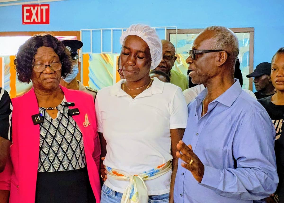 Edward Seaga Infant School Principal May Pinnock-Mitchell consoles Ladonna Cunningham, mother of three-year-old Jace Pinnock, and asks colleagues to support her and the family as they mourn his passing in a gun attack that also claimed the life of his fath
