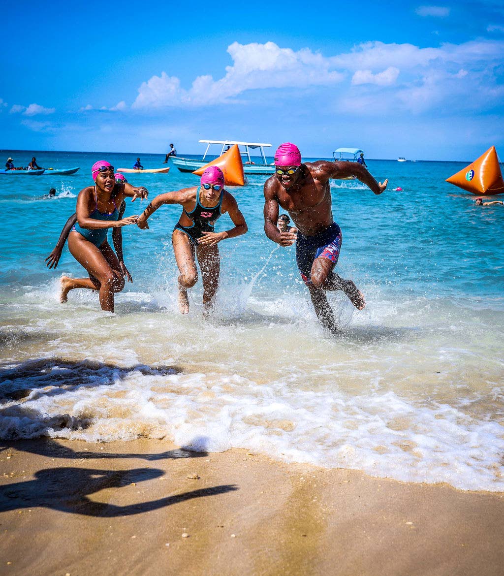 Here, friendly competition meets environmental advocacy as swimmers race for a cause at Swim For The Sanctuary. From left are Isabella Wong of the Tornadoes Swim Club; Emanuelle Spence, also of the Tornadoes, and Brandon Wong of the Y’Speedos Swim Club.