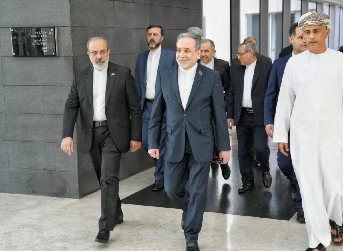 In this photo released by the Iranian Foreign Ministry, Iranian Foreign Minister Abbas Araghchi (centre), heads to the venue for talks between Iran and the US, in Muscat, Oman, Friday, February 6, 2026. 