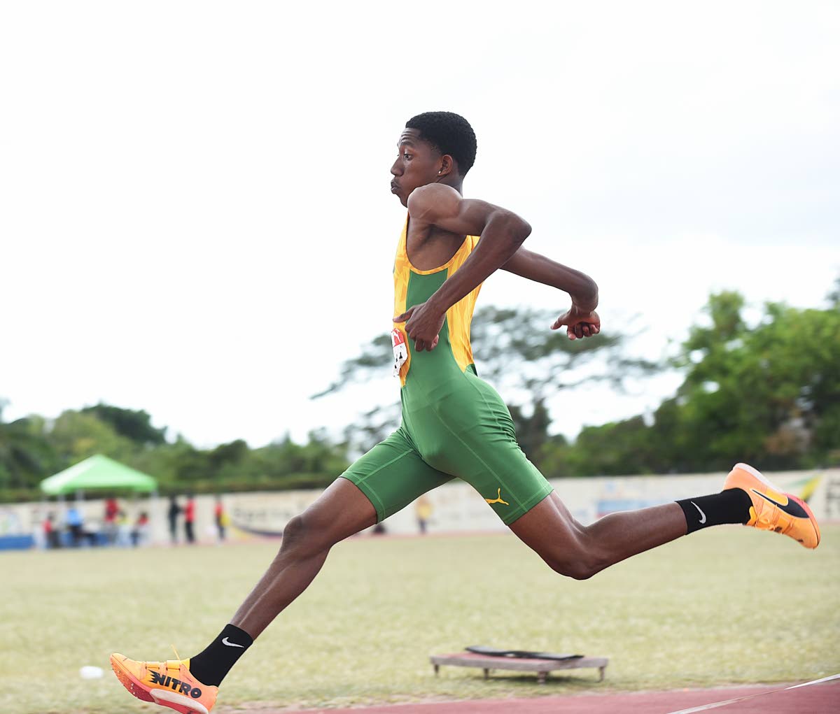 St Jago High School’s Winaldo Faulknor on his way to winning the Class 2 boys’ triple jump in a new meet record 14.00 metres at the ISSA Central Athletics Championships at G.C. Foster College yesterday.