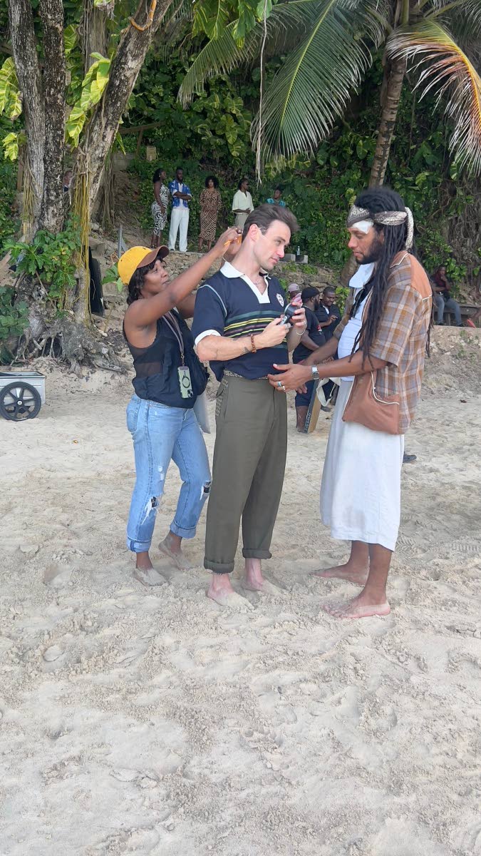 In between takes on Boston Beach, actor Thomas Doherty is tended to by hair stylist Melleisa Dawkins (left) and Jamaican-Scottish designer Nicholas Daley.