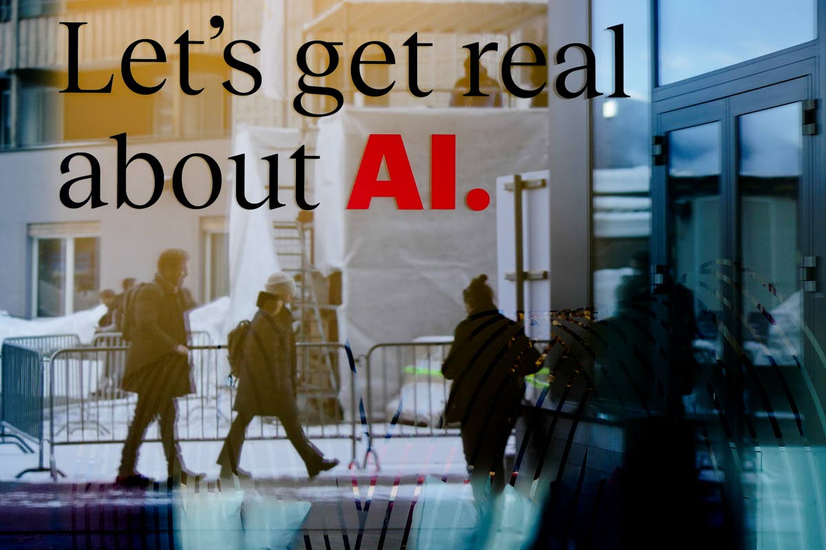 People reflected in a window of a hotel at the Davos Promenade with a slogan about AI alongside the World Economic Forum in Davos, Switzerland in January 2024. 