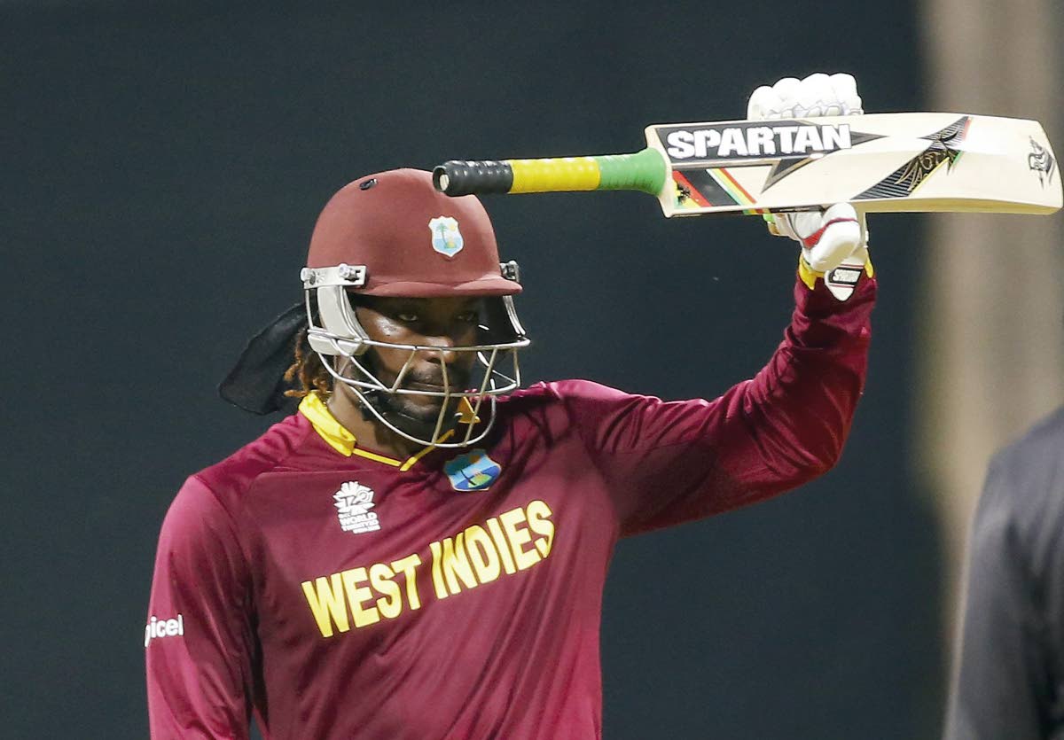 Chris Gayle raises his bat on the occasion of scoring a half-century on his way to the then fastest T20 World Cup century, against England at the Wankhede Stadium in Mumbai, India, in 2016.