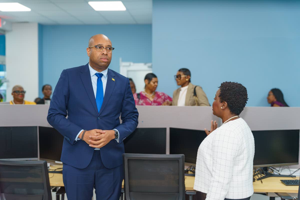 Delano Seiveright (right), state minister in the Ministry of Industry, Investment and Commerce, listens as Gloria Henry, vice-president of BPO and Logistics at the Port Authority, makes a point during a tour following the launch of the Portmore Incubator a