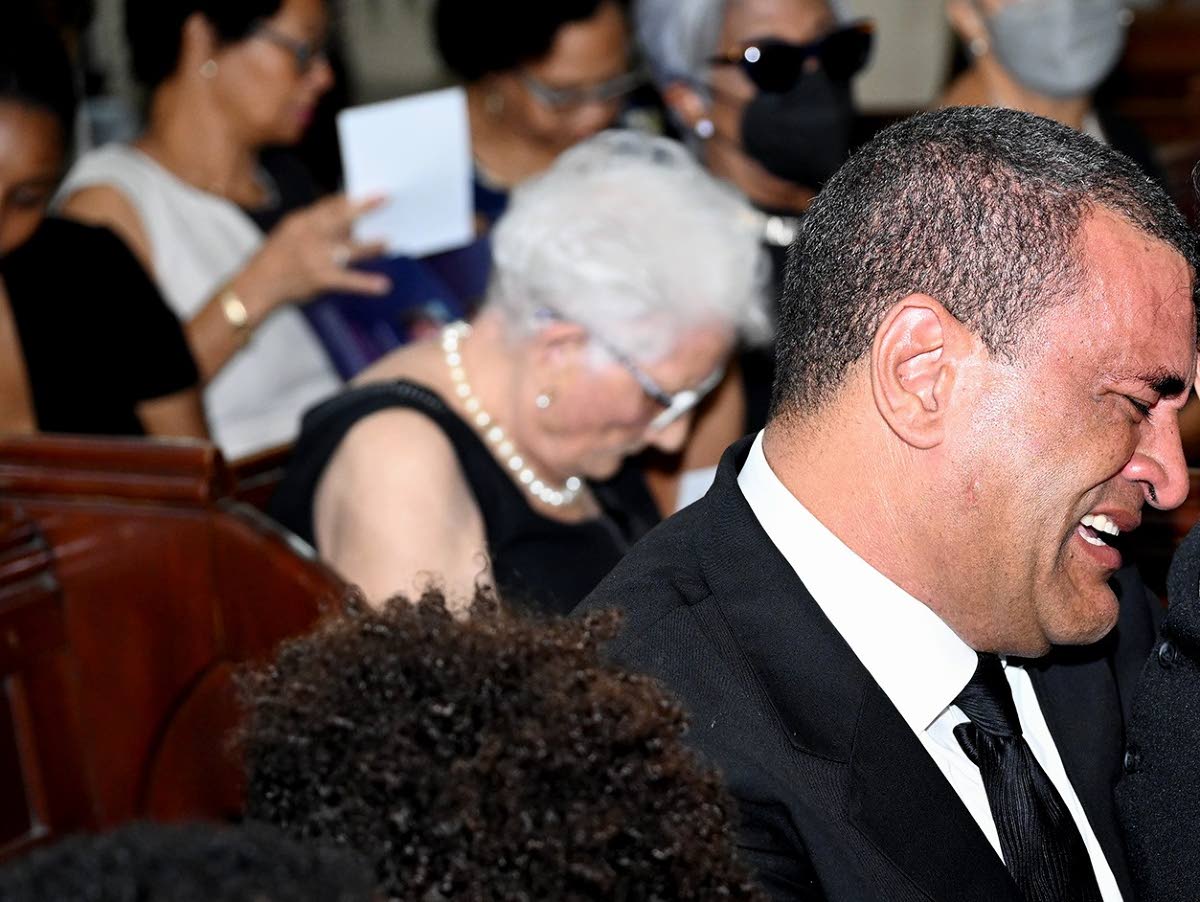 Jolyan Silvera sheds tears as he sits with his sons at the funeral service for his late wife Melissa Silvera at the St Andrew Parish Church on January 12, 2024.  (Rudolph Brown/Photographer)