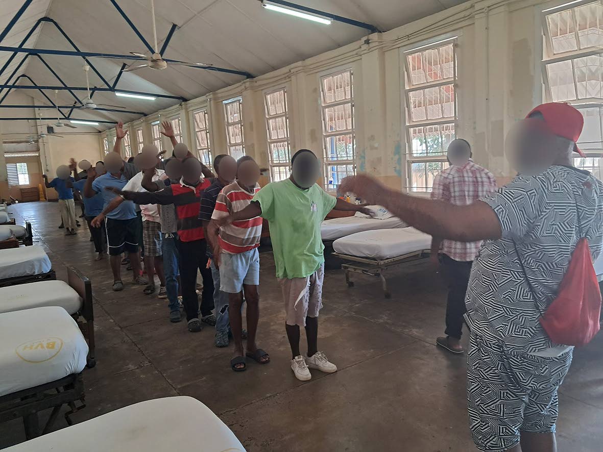  John Watson* leads a group in stretching exercises before lunch.