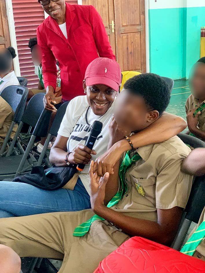 A student of Belair  High School is embraced by his guardian.