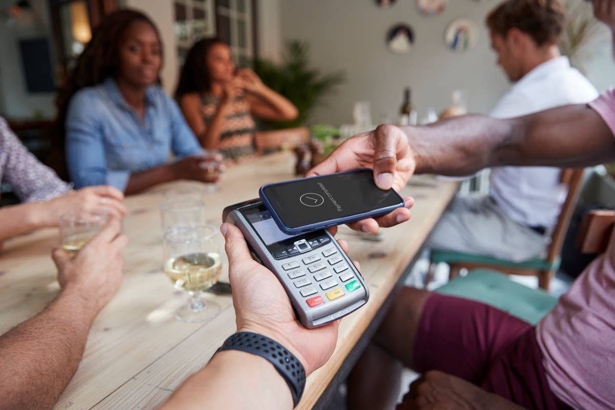 Man pays for meal with cell phone.