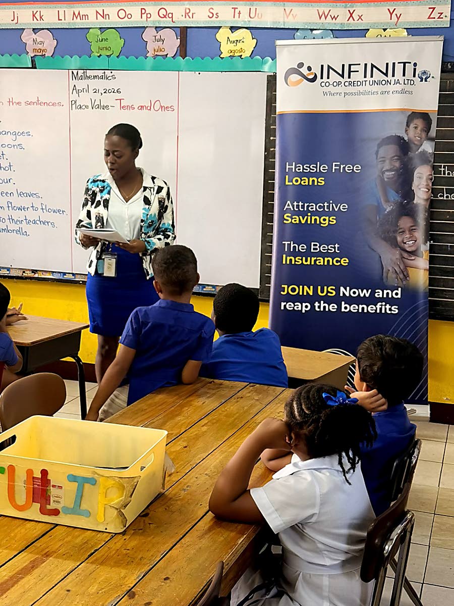An Infiniti staff volunteer reads ‘Tommy and the Money Tree’ to students at the Mount Alvernia Preparatory School during April’s Financial Literacy Month.