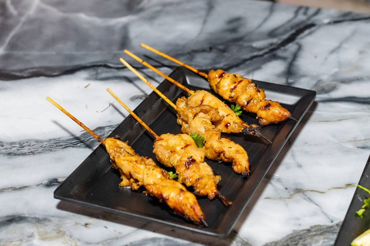 The ginger-kissed chicken satay pairs grilled chicken skewers with a ginger-peanut sauce, finished with a hint of lime.