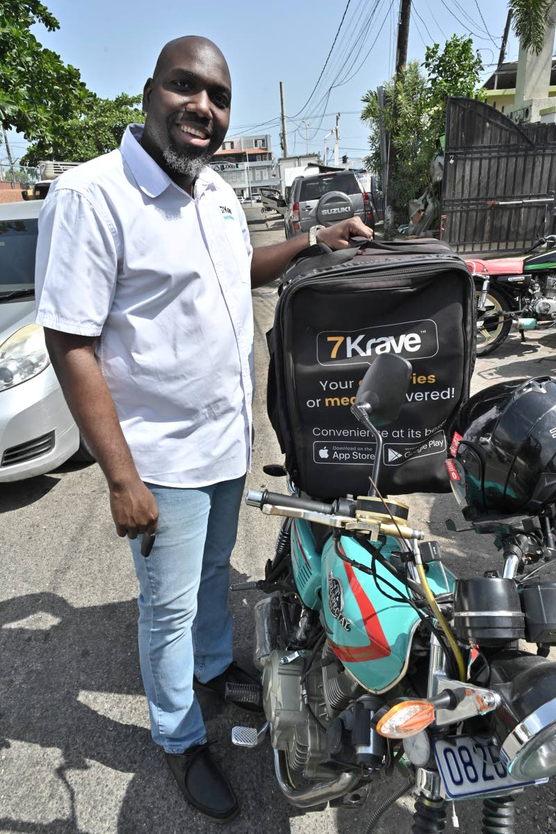 Rory White poses with 7Krave’s branded delivery bike and bearer bag, symbols of his vision to transform how Jamaicans access food and other essentials.

