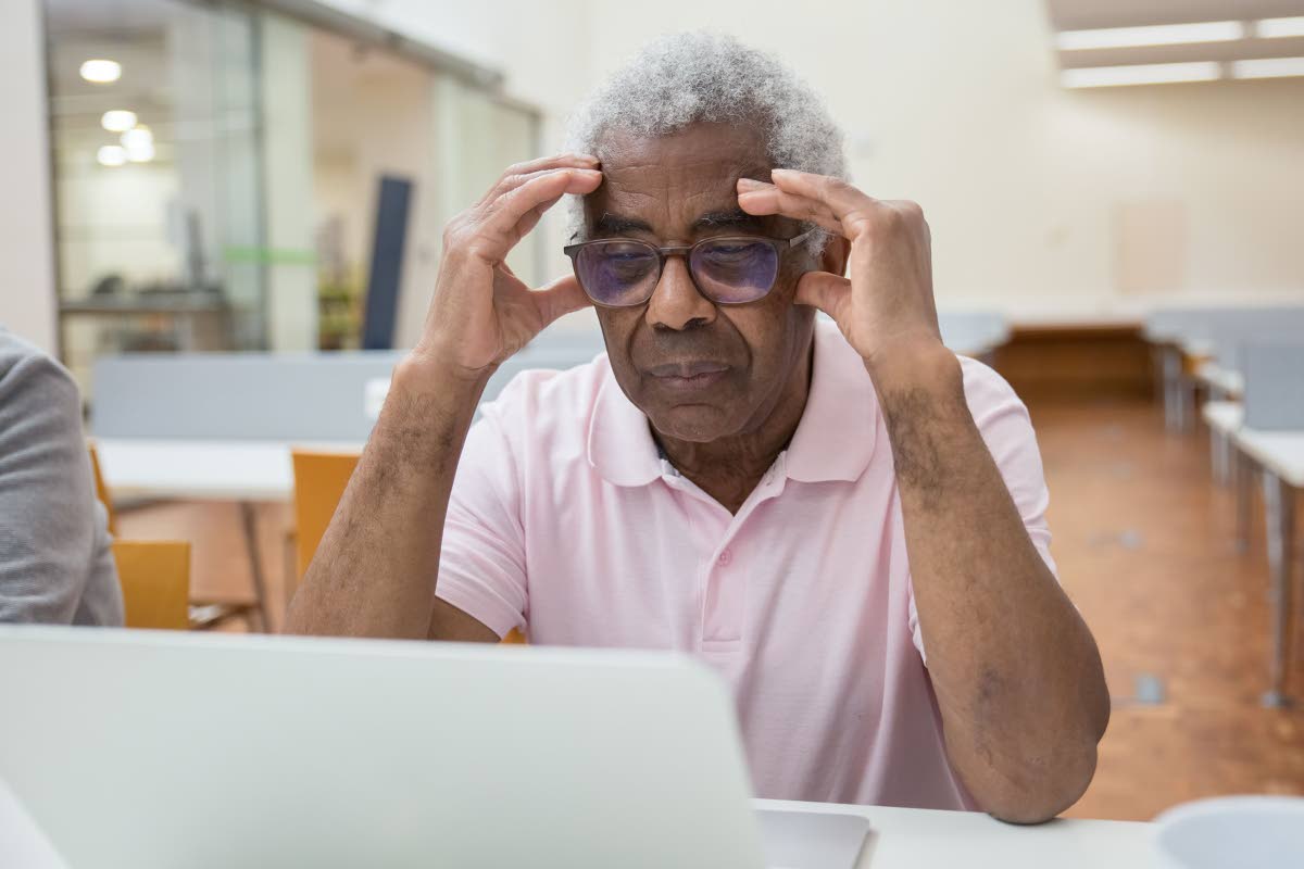 Representational image of a senior citizen having difficulties with technology.