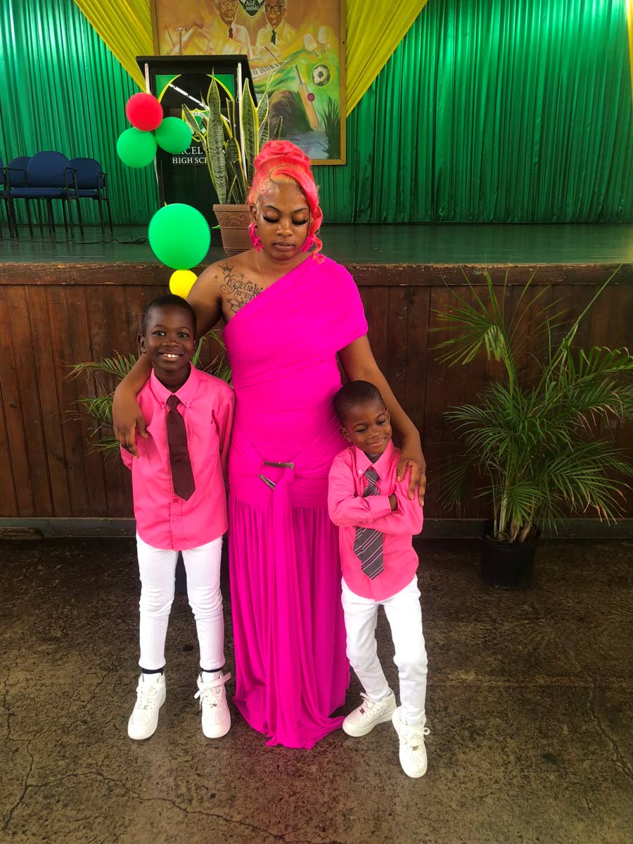Josephine Mitchell and her boys at the thanksgiving service for Kemelia Paul on Sunday.