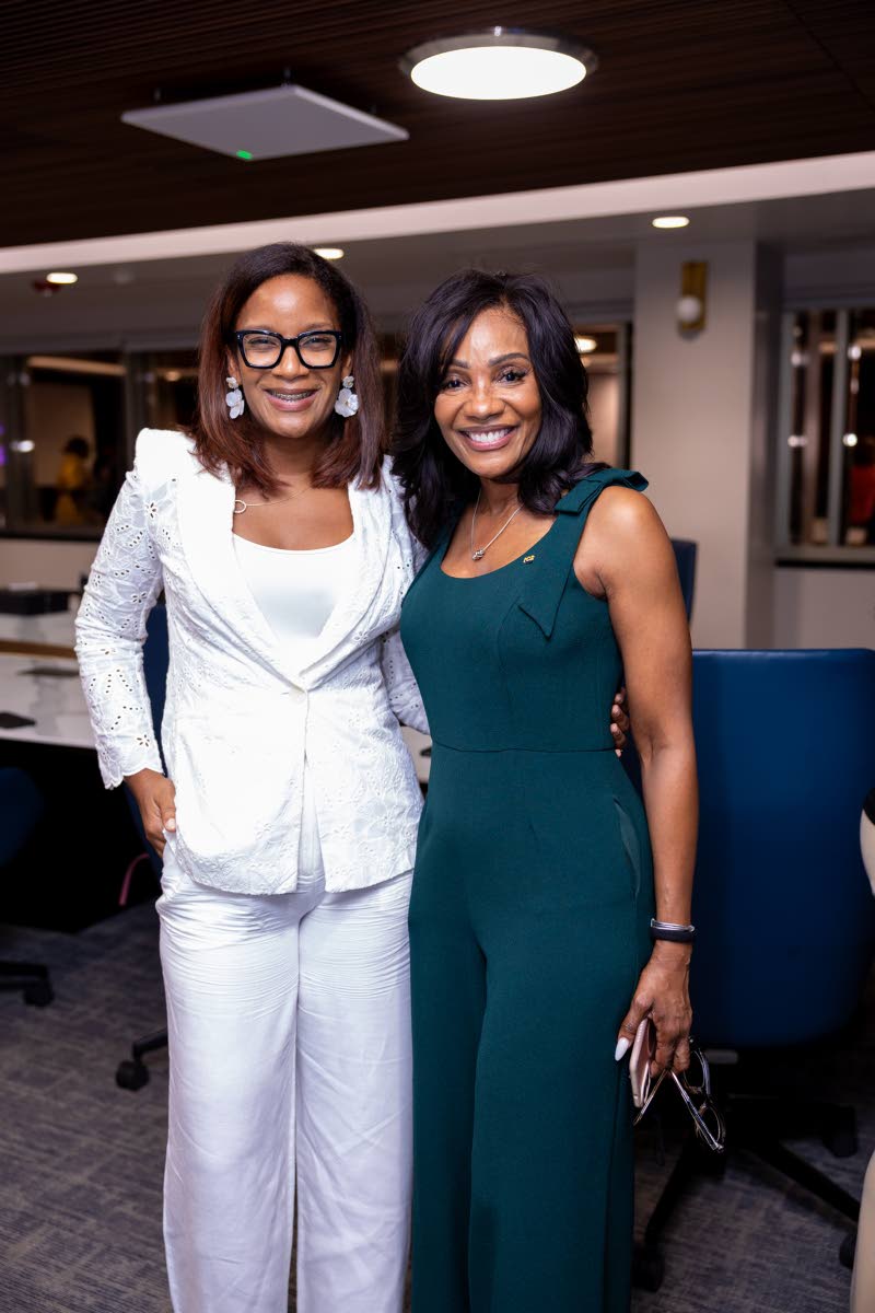 Janelle Pantry-Coke’s all-white suit provides the perfect contrast to Belinda Williams’ forest-green sleeveless jumpsuit.