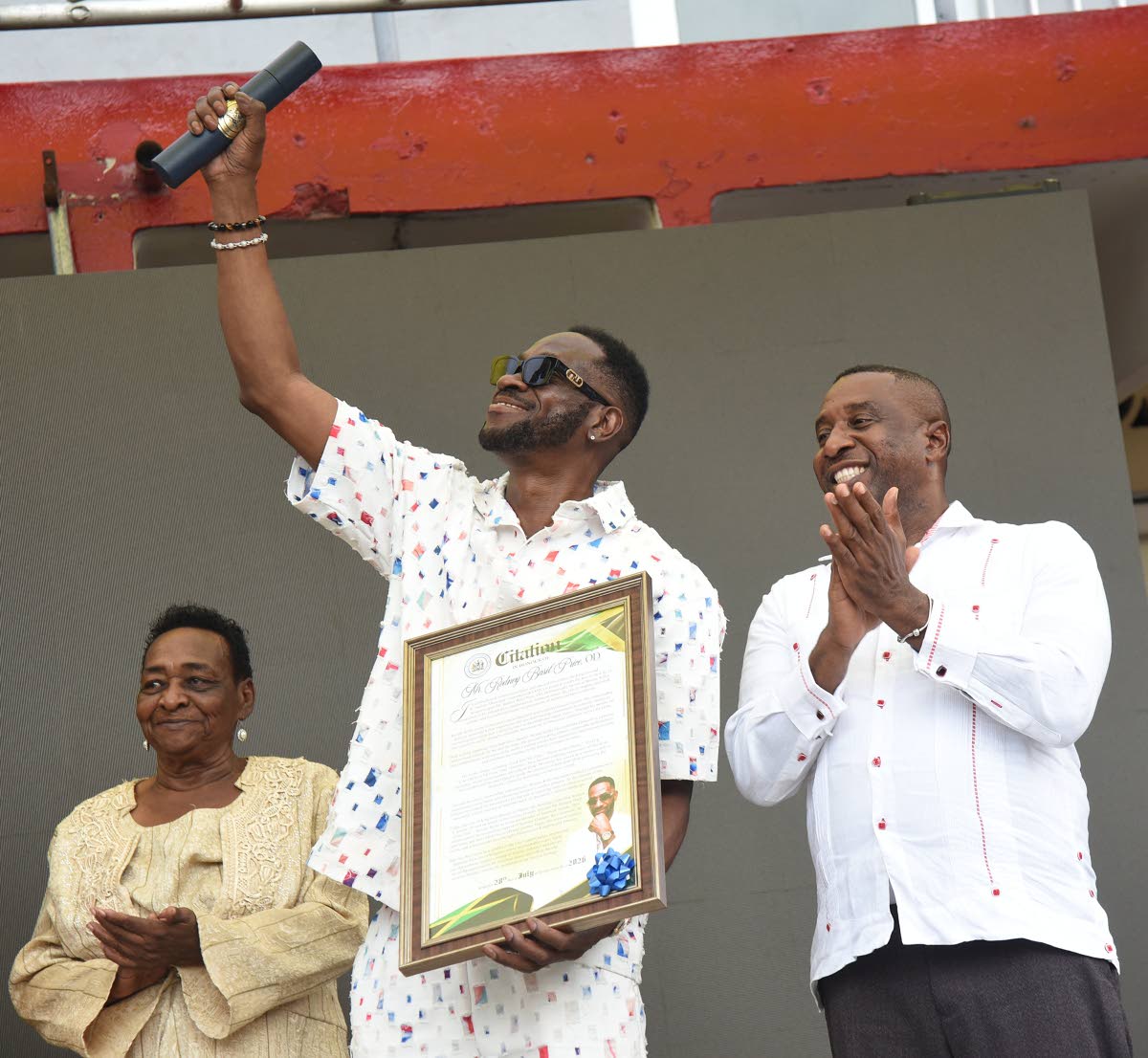 Rodney ‘Bounty Killer’ Price displays his citation after receiving the Key to the City of Kingston from Mayor of Kingston Andrew Swaby (right). 