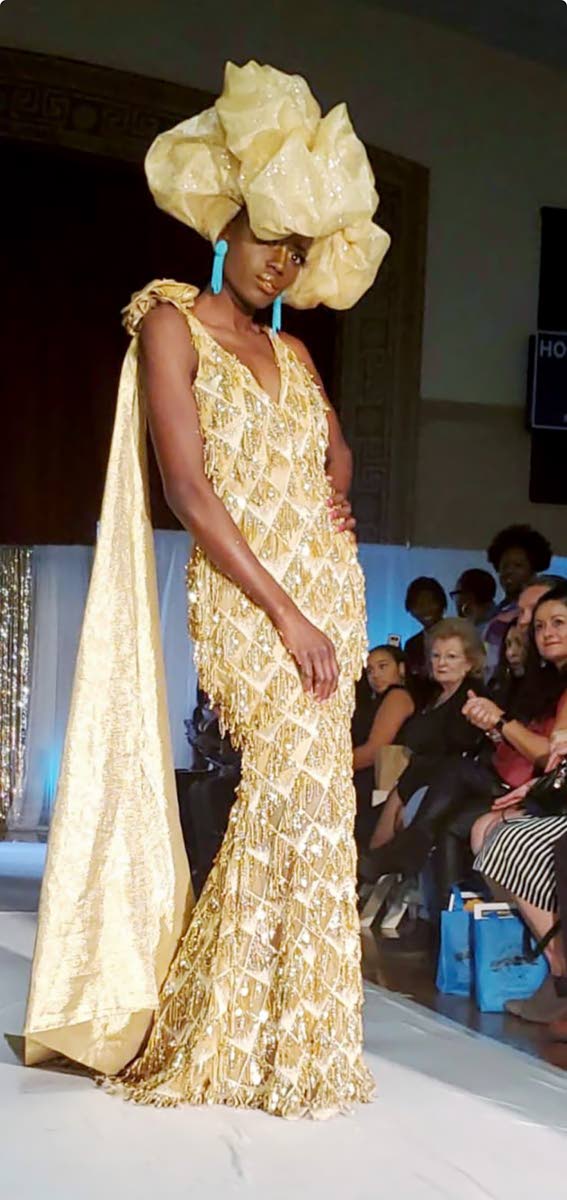 Keisha Black wears a fringe diamond gold gown with a scarf made from burlap by Hope Wade.