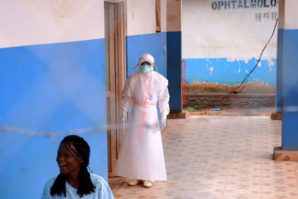 A health worker, wearing protective gear, stands outside the Ebola Treatment Center at the Bunia General Hospital in Ituri, Congo, on Wednesday.