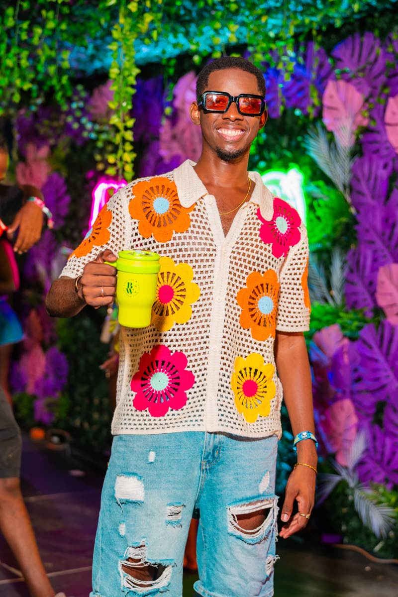 Xander Gregory brings a laid-back vibe to the fête in a retro floral crochet shirt, distressed denim and shades to complete the look.
