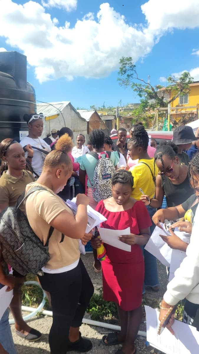 Teachers of Maud McLeod handing out lessons to students who were not able to attend school in person.