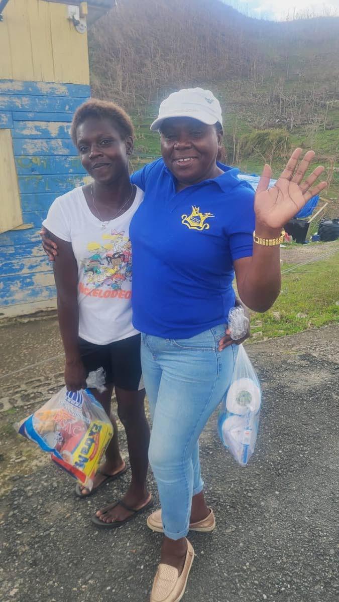 Principal of Maud McLeod Beverley Feare hands out a care package to one of her students after Hurricane Melissa.