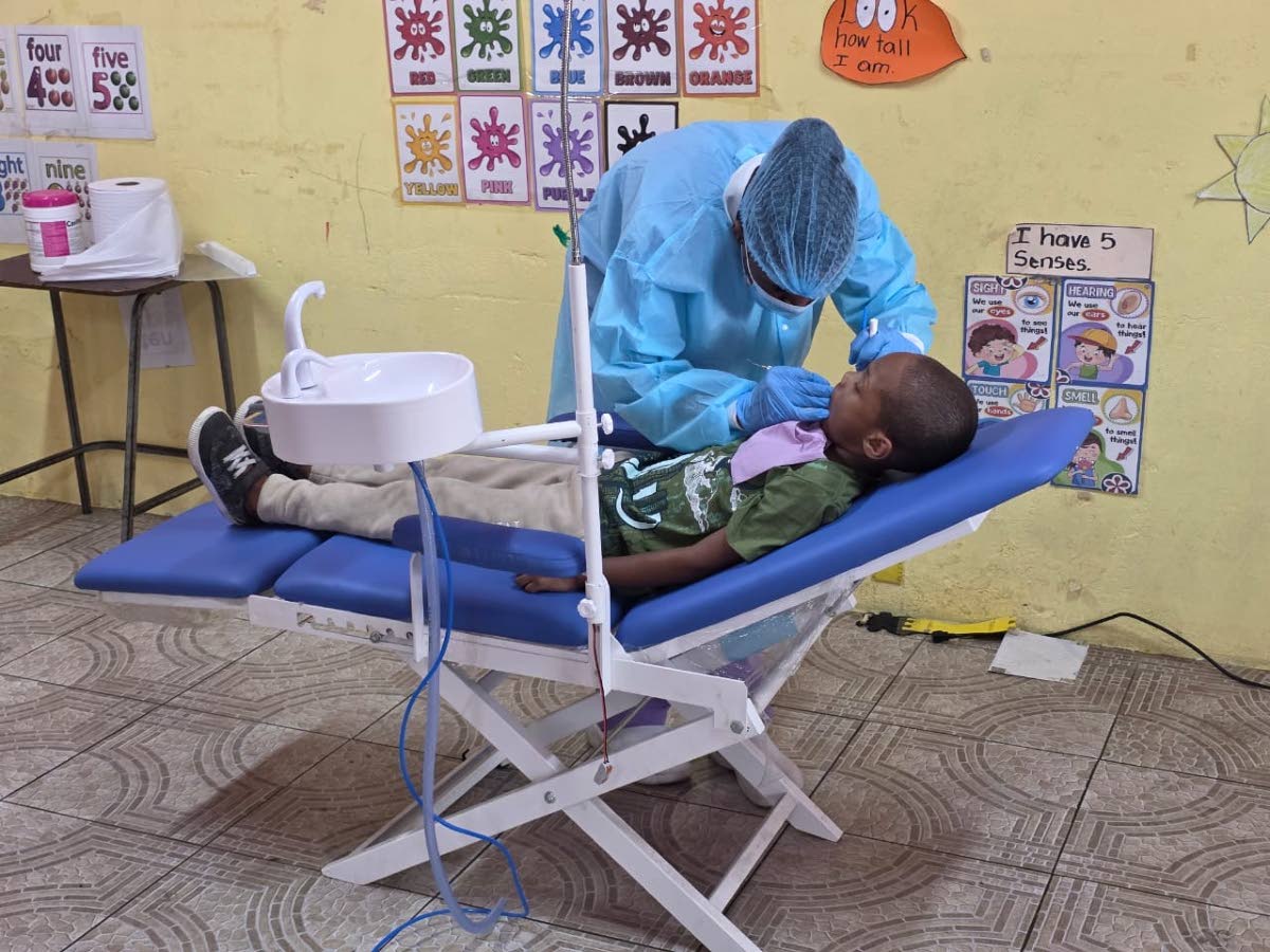 A child has his teeth examined and cleaned by a member of the FLOSS International dental team during the Rotary Club of Trafalgar New Heights’ health fair for the community of Maverley recently. The event was held at the Maverley Primary and Infant Schoo