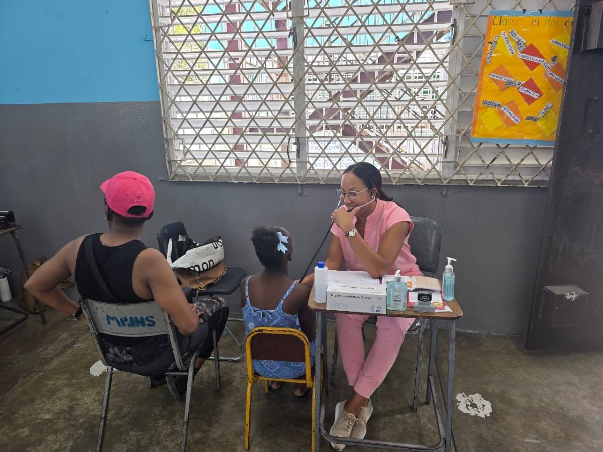 Dr Tiffany Hunter, a member of the Rotary Club of Trafalgar New Heights, examines a child during the 15th staging of the Rotary Club of Trafalgar New Heights’ health fair for the community of Maverley recently. The event was held at the Maverley Primary 