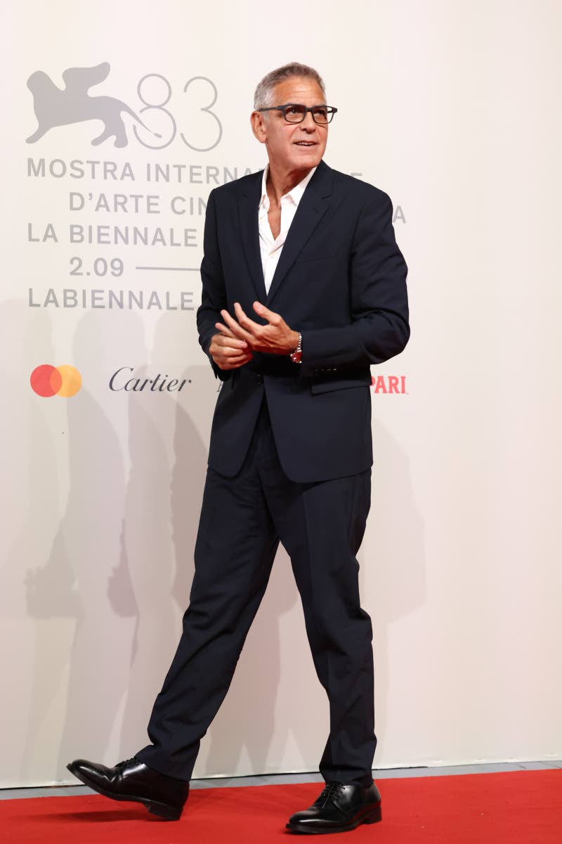 A jovial George Clooney poses for photographers at the ‘Furies’ red-carpet premiere. Clooney is an executive producer of the film.