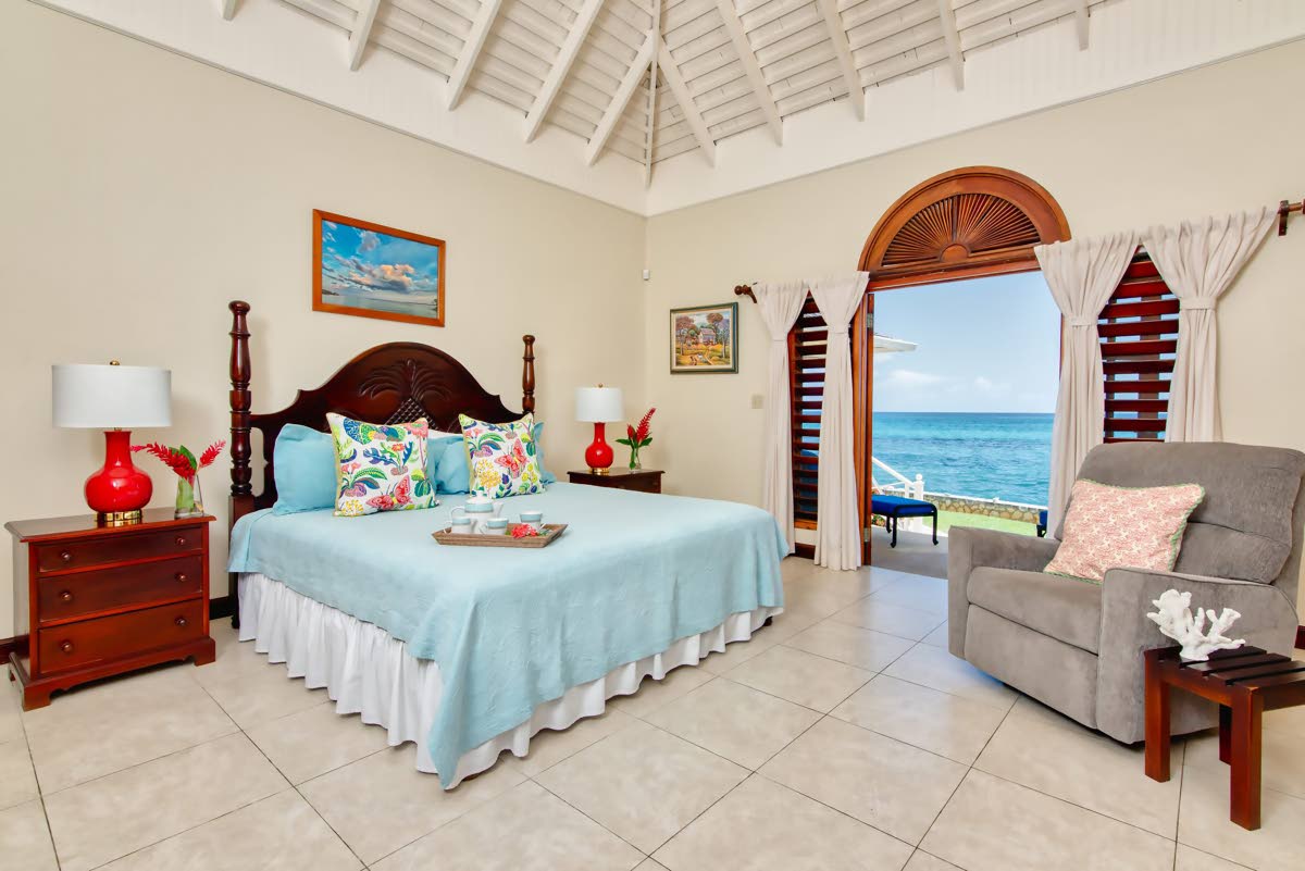 A bedroom mere footsteps from the seashore. 