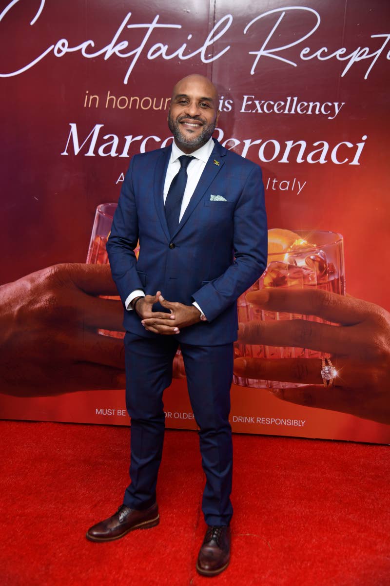 Suited in navy blue and with a winning smile to match is Robert Hill, chief executive officer of the Kingston and St Andrew Municipal Corporation.