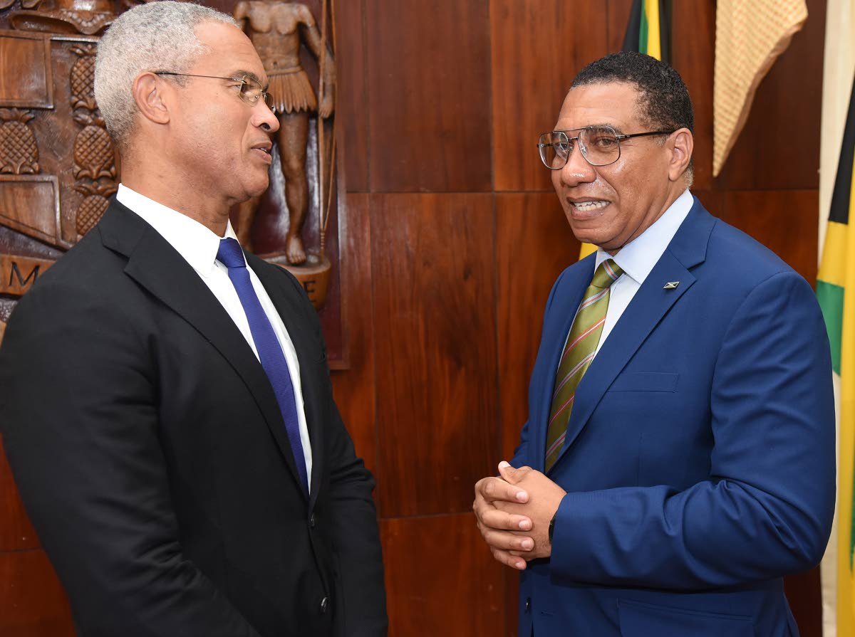 Prime Minister Dr Andrew Holness (right) chats with Professor Peter Blair Henry (left), chair of the Jamaica Reconstruction and Resilience Oversight Committee (JAMRROC), during the official launch at Jamaica House on Tuesday. – Ian Allen photo