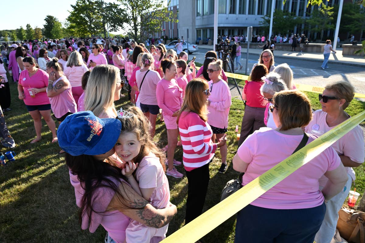 Kara Hurston holds her daughter Prinn, 4, as they join a demonstration in support of Lindsay Clancy outside Plymouth Superior Court, where Clancy is on trial in connection with the deaths of her three children, Thursday, August 20, 2026, in Plymouth, Massa