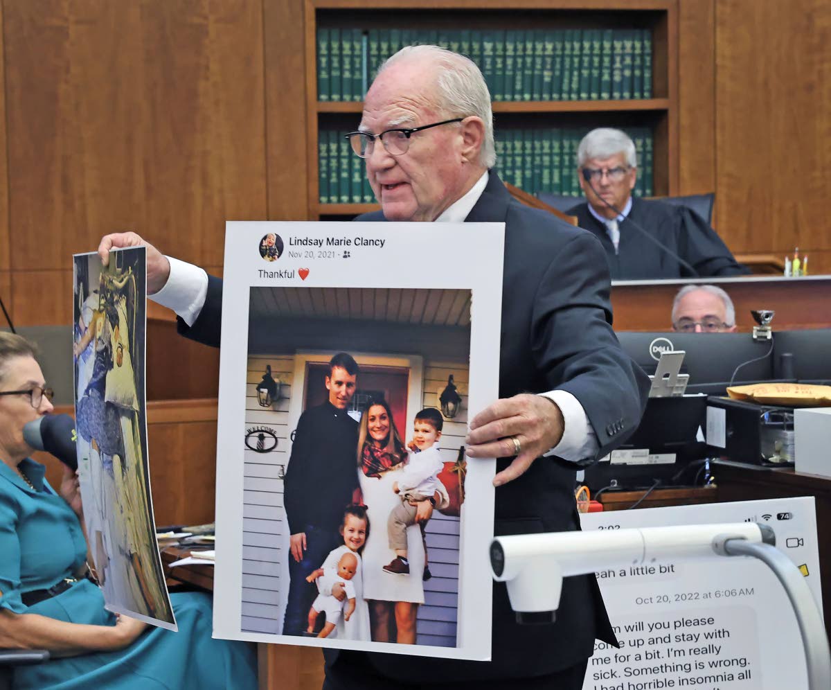 Defence attorney Kevin Reddington holds up a picture of the Clancy family before the murders during closing arguments in the Lindsay Clancy murder trial at Plymouth Superior Court in Plymouth, Massachusetts, Thursday, August 27, 2026. 